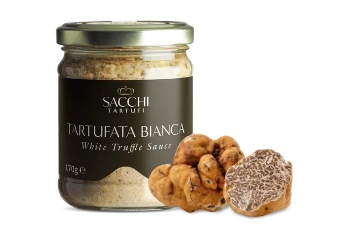 Sacchi Tartufi white truffle sauce jar with fresh white truffles displayed beside it