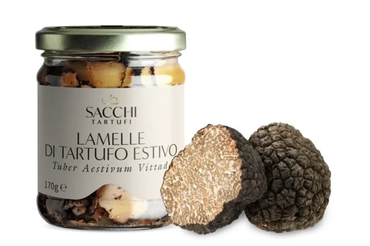 Jar of Sacchi summer truffle slices with whole and cross-section black truffles beside it