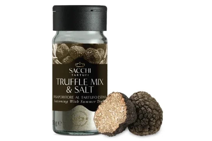 Bottle of Sacchi truffle mix and salt seasoning with two whole truffles beside it